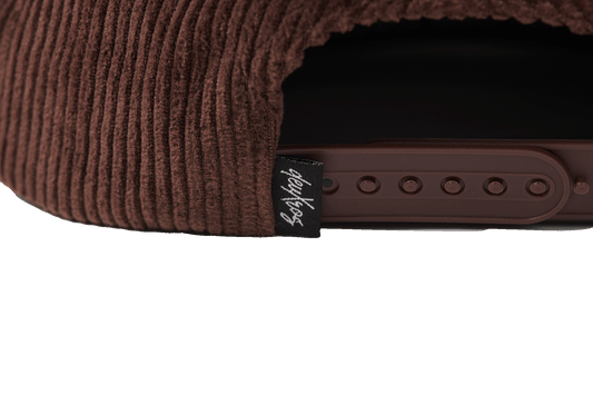 deuXros brown corduroy hat closure detail, adjustable strap with woven script label, tonal details