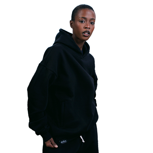 Color: Ink hoodie women's upper body lifestyle shot, overlapped neckline, tonal matte 3d rubberized box logo
