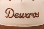 deuXros snapback close-up embroidery detail, tonal brown script on cream canvas