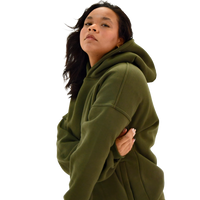 Person wearing a field moss deuxros hoodie on a white background