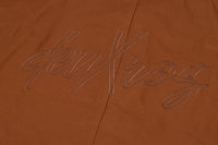 Close-up of deuxros logo on brown leather