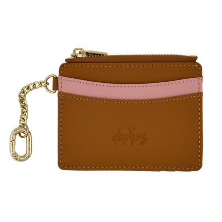 A brown leather card holder wallet with a pink textured stripe across the middle, a gold zipper, and a gold keychain attachment. The brand name 'deuXros' is embossed on the front.
