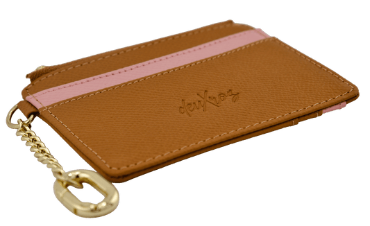 A brown leather card holder wallet with a pink textured stripe across the middle, a gold zipper, and a gold keychain attachment. The brand name 'deuXros' is embossed on the front.