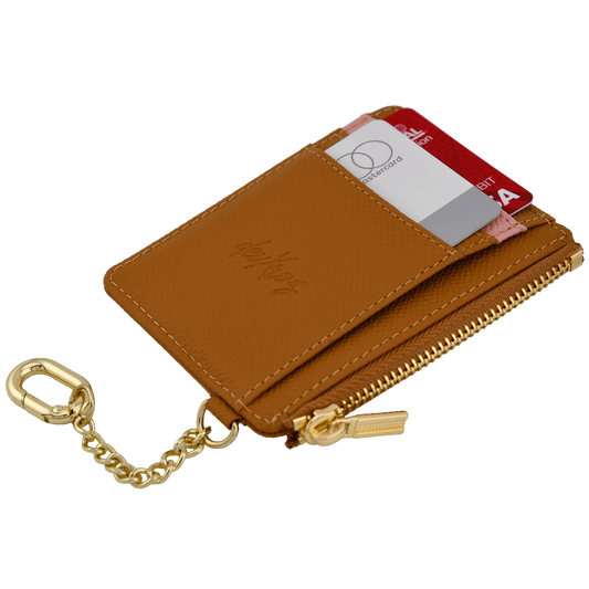 A brown leather card holder wallet with a pink textured stripe across the middle, a gold zipper, and a gold keychain attachment. The brand name 'deuXros' is embossed on the front.